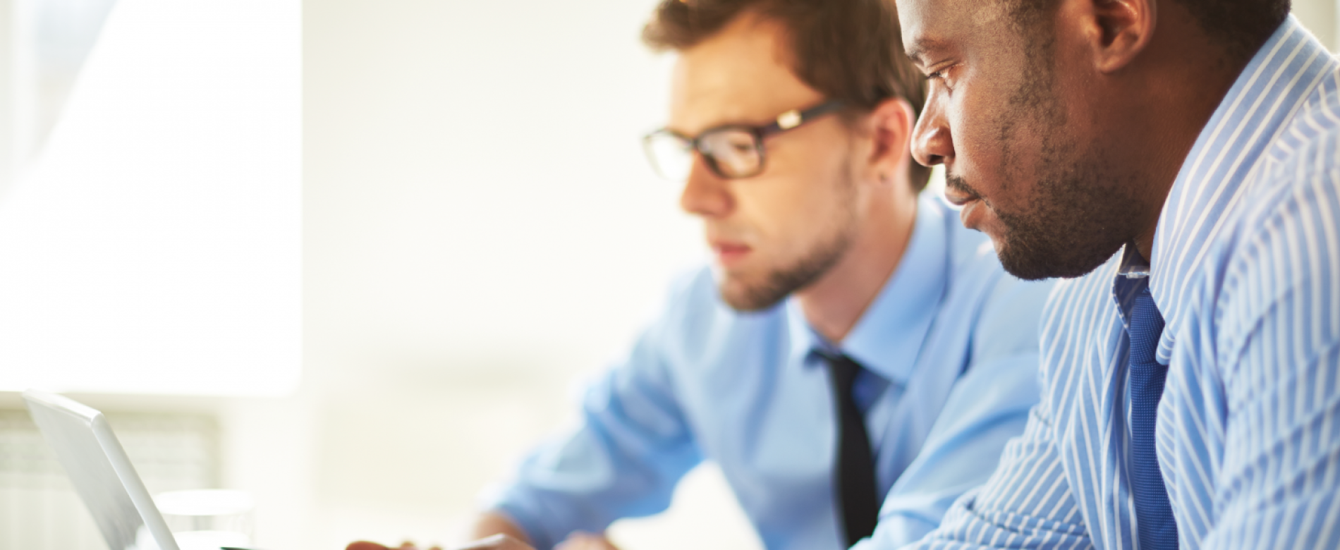 Two men work at a computer