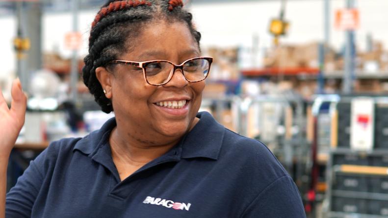 Paragon employee smiling and waving