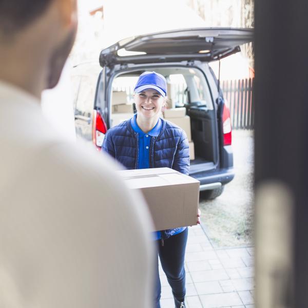 Delivery-girl-carrying-box-customer