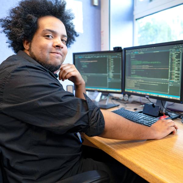 Software developer with multiple computer screens