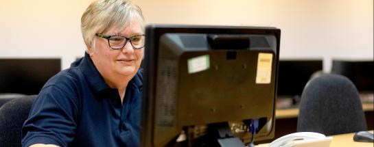 Lady sat at desk with computer screen