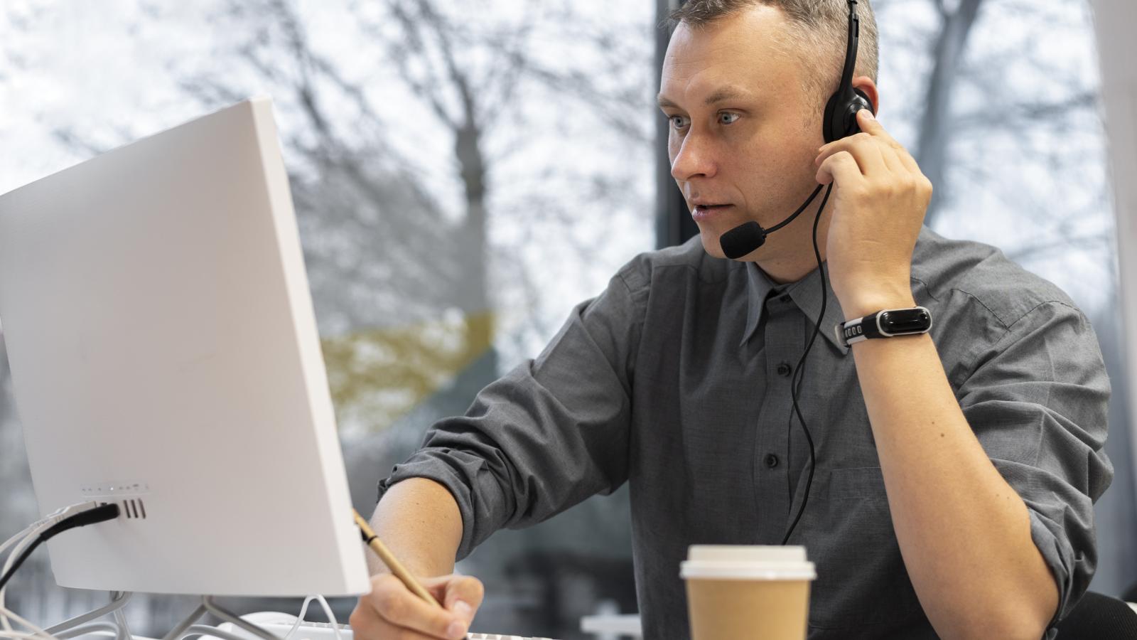 man-working-call-center-with-headphones-computer