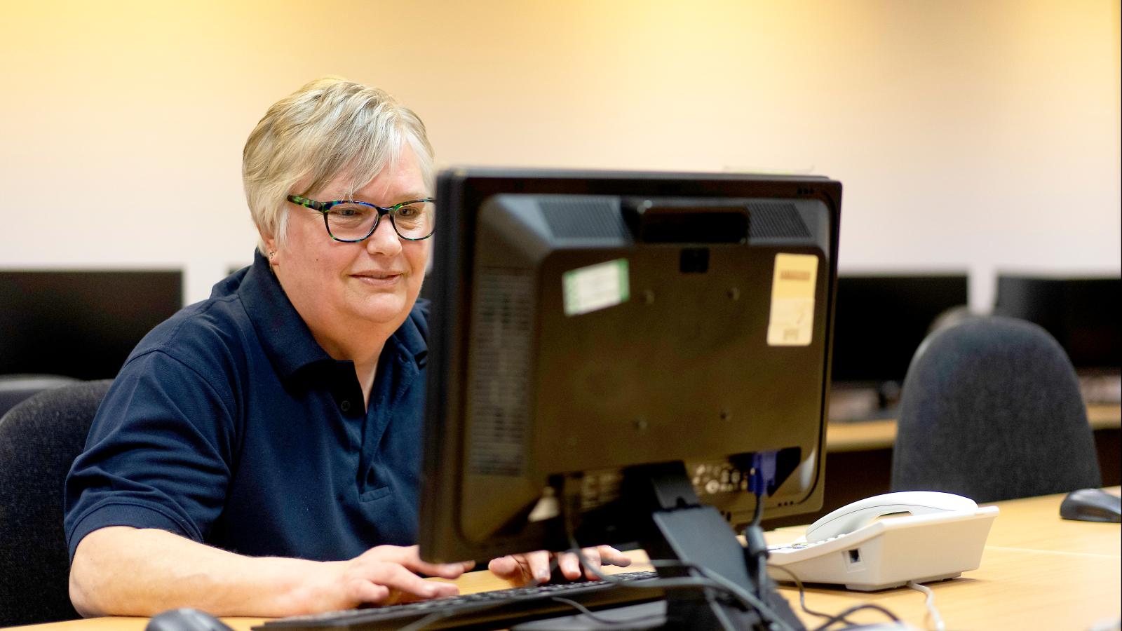 Lady sat at desk with computer screen