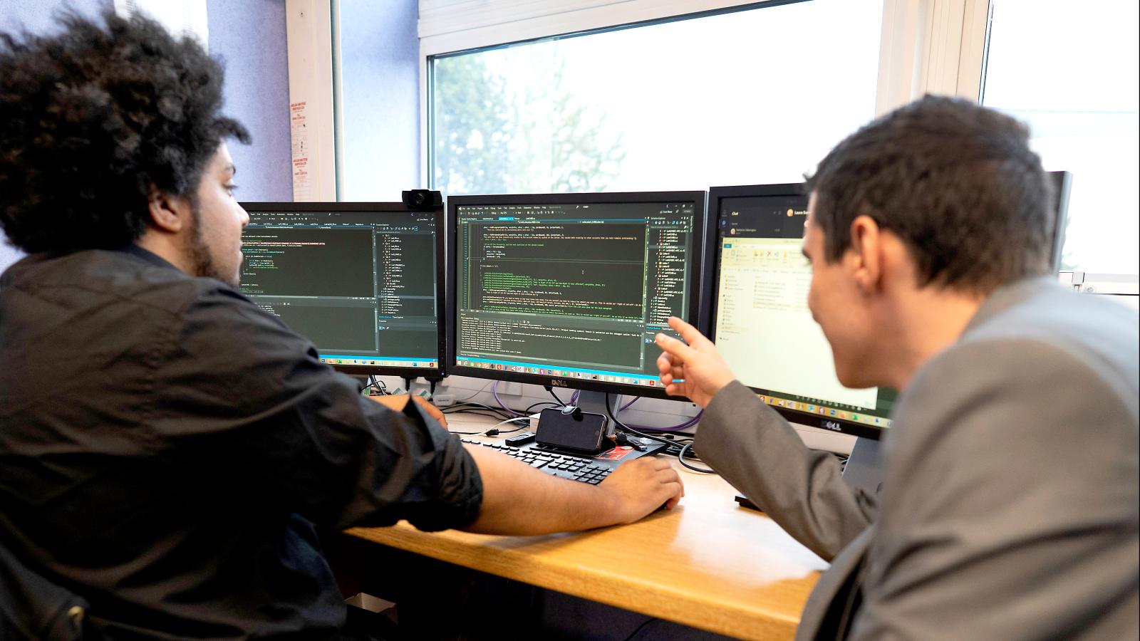 Two men at a computer 